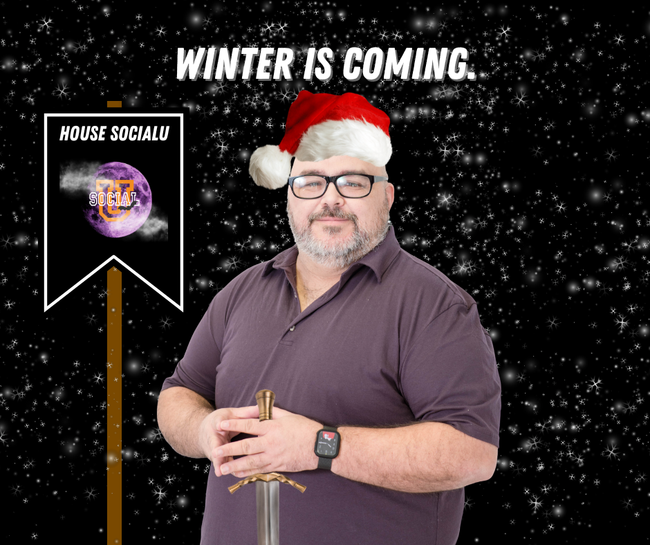 A man with a Santa hat holding a sword.